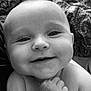 Chloe Ann is registered to the contest to win money with this photo: baby, smiling, close_up, black_and_white, chubby_cheeks, hands, infant, portrait, cute, happy, skin, face, eyes, young_child, person, expression, indoors, soft_light, background, patterned_fabric