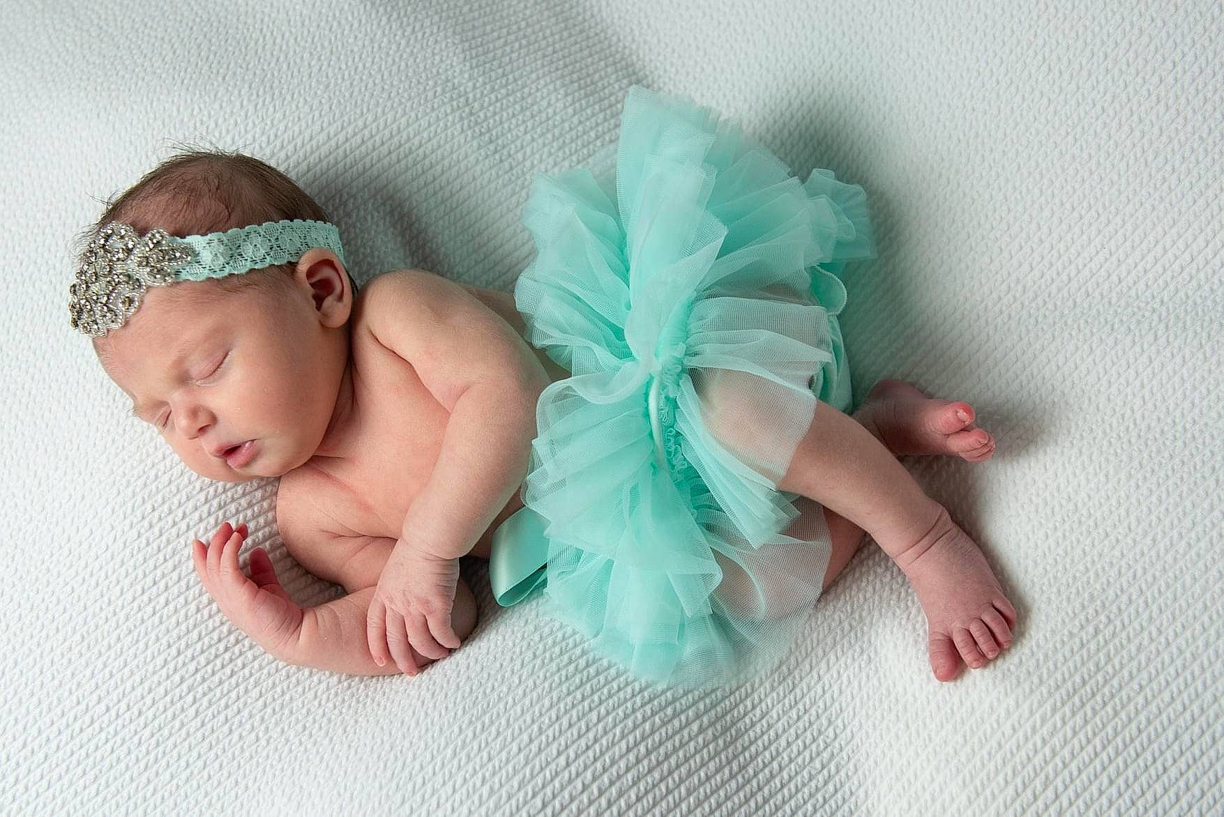 Amelia is registered to the contest to win money with this photo: baby, baby_products, baby_sleeping, baby_toddler_clothing, beanie, cap, child, comfort, fashion_accessory, finger, grass, hair_accessory, headband, headpiece, headwear, jewellery, knit_cap, linens, pattern, person