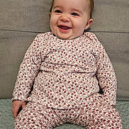 Ilona participe au concours pour gagner de l'argent avec cette photo : baby, child, smiling, pajamas, floral_pattern, sitting, couch, blanket, footwear, indoors, happy, cute, portrait, cozy, clothing, person, infant, soft_texture, head, face
