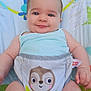 baby, child, infant, blue_eyes, tank_top, diaper_cover, sloth_print, baby_seat, colorful, smile, cute, chubby_cheeks, hair_tuft, skin, indoor, comfort, happy, portrait, playful, young