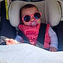 baby, car_seat, sunglasses, pacifier, blanket, child, infant, seatbelt, pink, clothing, sunlight, shadow, floral_pattern, cute, young_child, indoor, portrait, comfort, resting, head_support