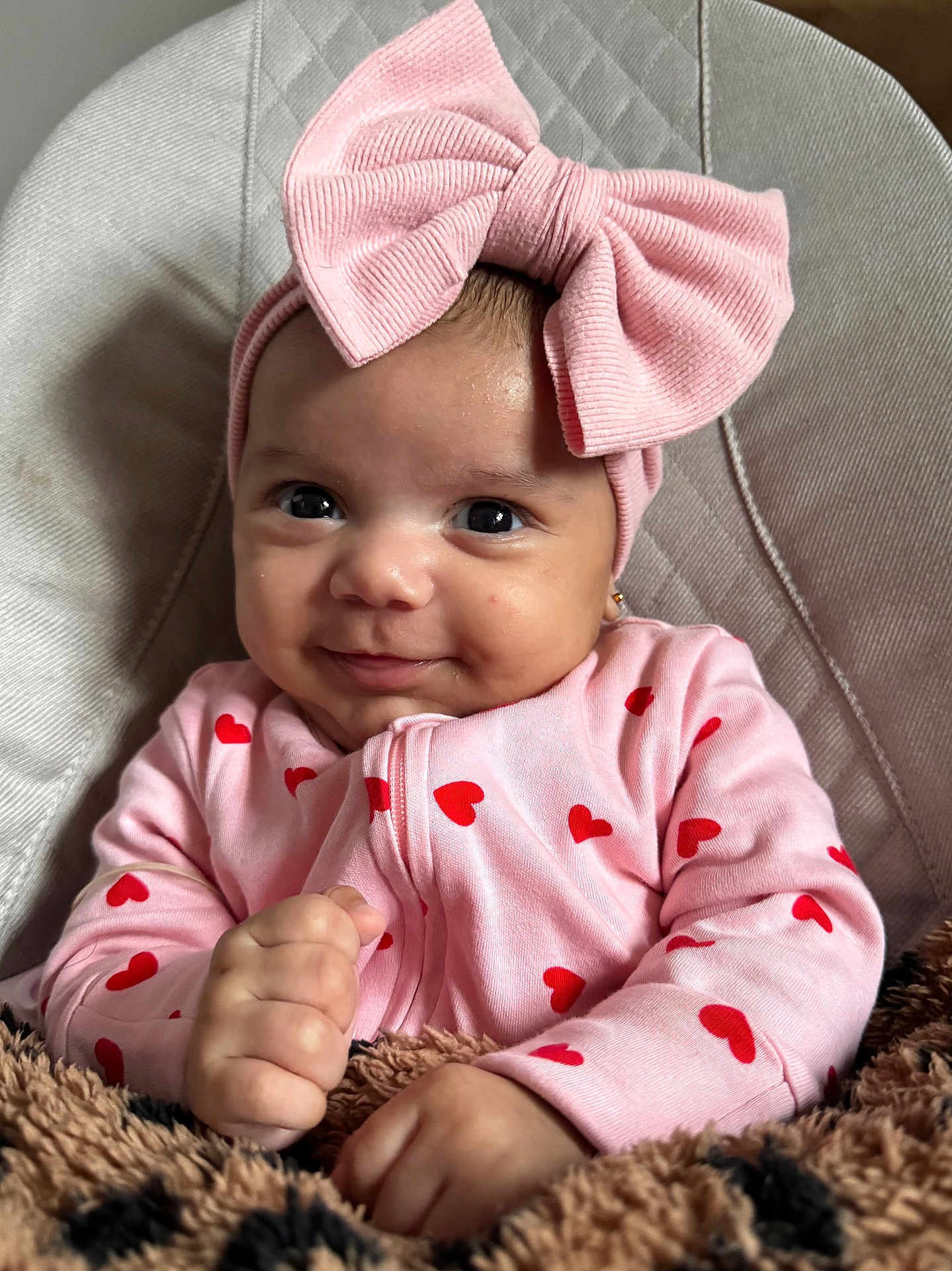 Matilda joined the competition — help win amazing prizes! baby, pink_bow, headband, pink_outfit, red_hearts, smiling, infant, blanket, fuzzy_blanket, cushioned_seat, cute, portrait, hands, face, clothing, indoor, adorable, child, young_baby, cozy