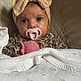 Matilda joined the competition — help win amazing prizes! baby, infant, pacifier, headband, bow, blanket, leopard_print, toy, couch, knitwear, clothing, face, eyes, indoor, portrait, child, cute, comfort, soft, expression