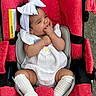 Aitana joined the competition — help win amazing prizes! baby, child, stroller, red, white_bow, headband, socks, white_clothing, infant, cute, baby_girl, fingers_in_mouth, seated, cushion, outdoor, warning_label, fabric, comfort, portrait, person