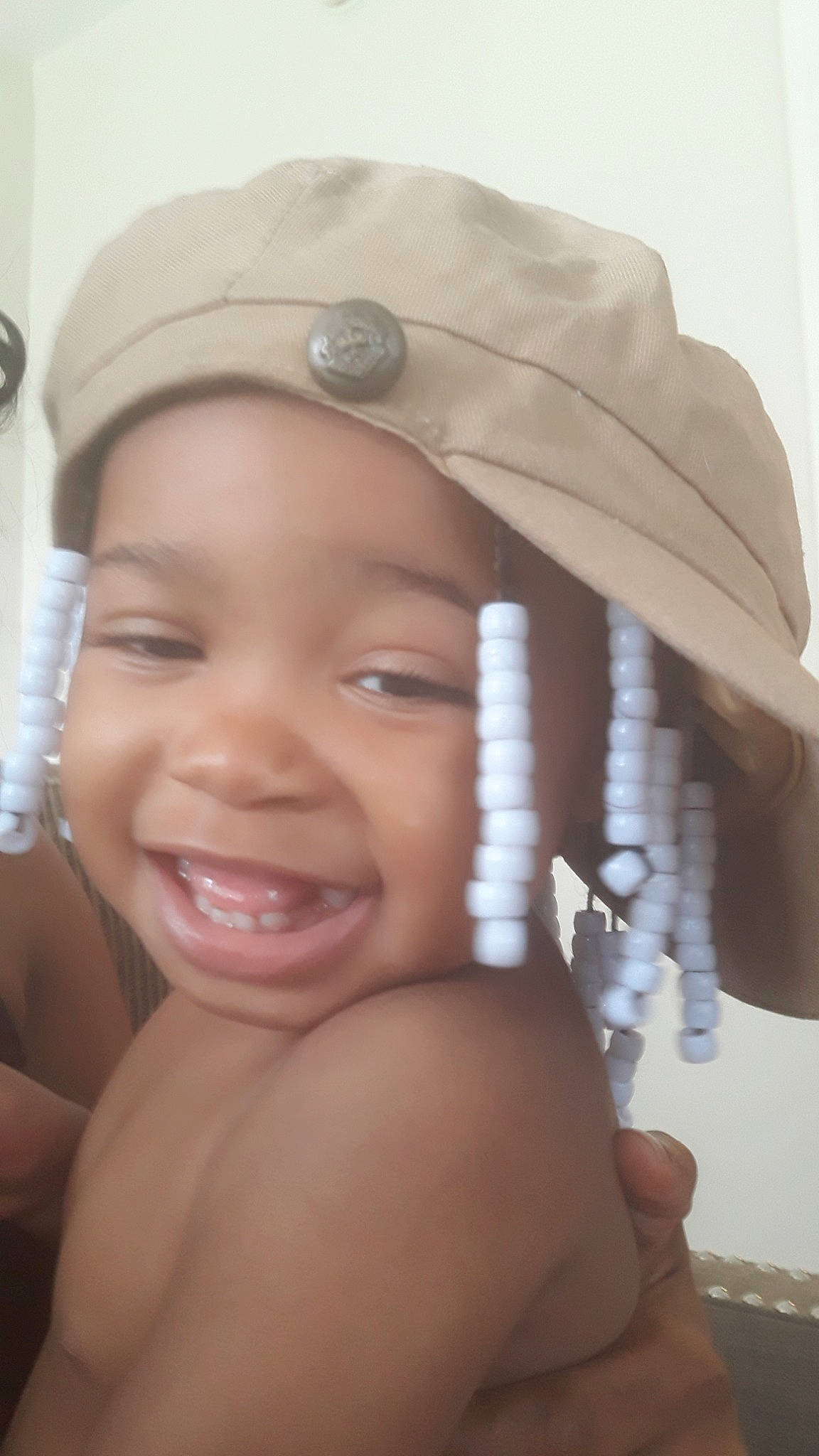 Kahealani is registered to the contest to win money with this photo: bonnet, child, eyebrow, face, fashion_accessory, forehead, head, headgear, headpiece, joy, lip, person, skin, smile