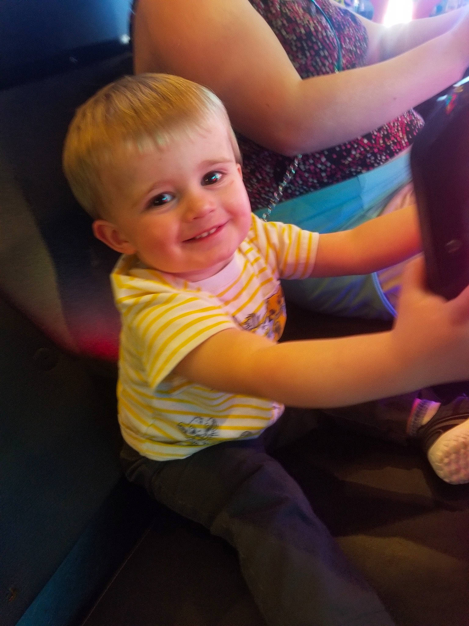 Tidus is registered to the contest to win money with this photo: arm, baby, blond, cheek, child, elbow, eye, face, finger, fun, happy, iris, joy, lap, person, play, sitting, skin, smile, toddler