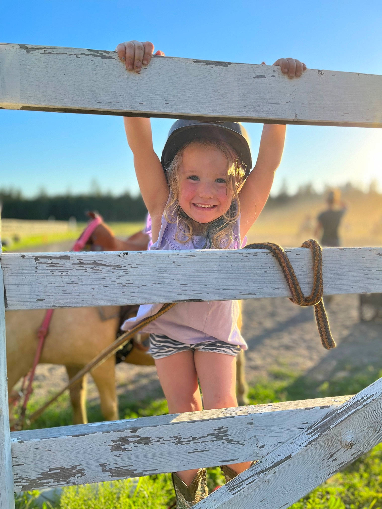 Berklee is registered to the contest to win money with this photo: blond, fawn, fence, fun, grass, grass_family, grassland, happy, headwear, joy, landscape, leisure, people_in_nature, person, rural_area, shorts, sky, smile, summer, sunlight