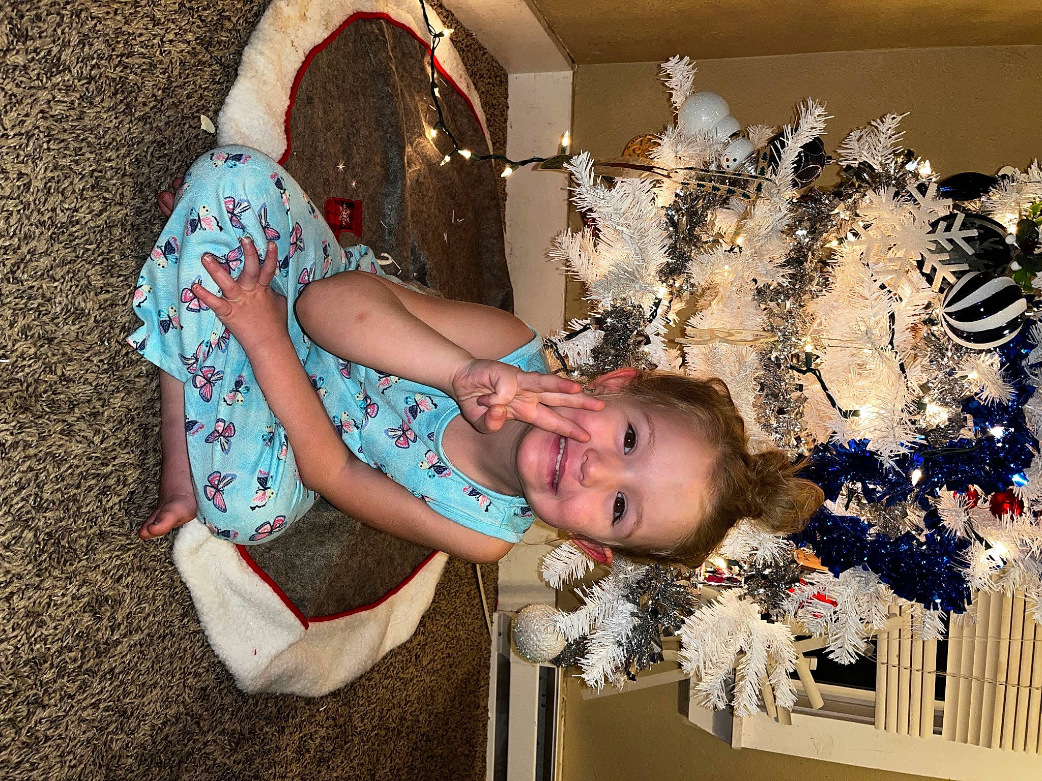 Berklee is registered to the contest to win money with this photo: baby, child, christmas, christmas_decoration, christmas_eve, christmas_ornament, event, fashion_accessory, fun, happy, holiday, human_leg, interior_design, joy, leisure, ornament, pattern, person, portrait_photography, sitting