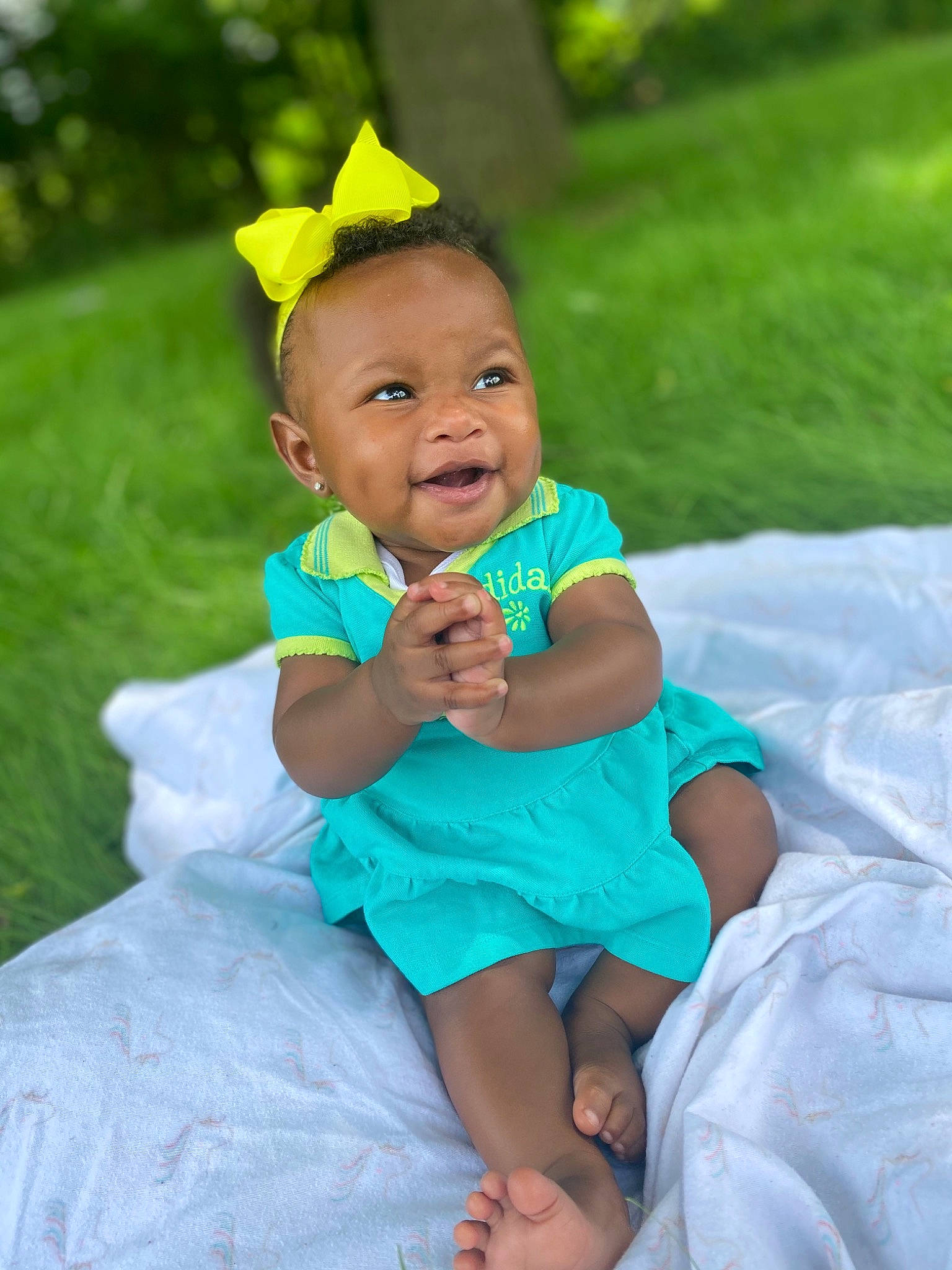 Kara joined the competition — help win amazing prizes! baby, baby_toddler_clothing, child, dress, electric_blue, event, eye, fun, grass, happy, headpiece, jewellery, leisure, people_in_nature, person, pink, plant, recreation, sitting, smile