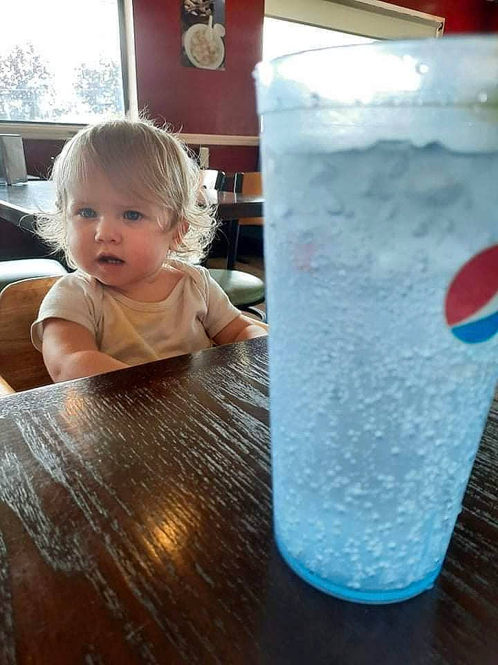 Skylar joined the competition — help win amazing prizes! baby_toddler_clothing, child, cylinder, drink, drinking_water, drinkware, glass, highball_glass, ice_cube, liquid, mineral_water, person, pint, pint_glass, plastic_bottle, soft_drink, table, tableware, toddler, water