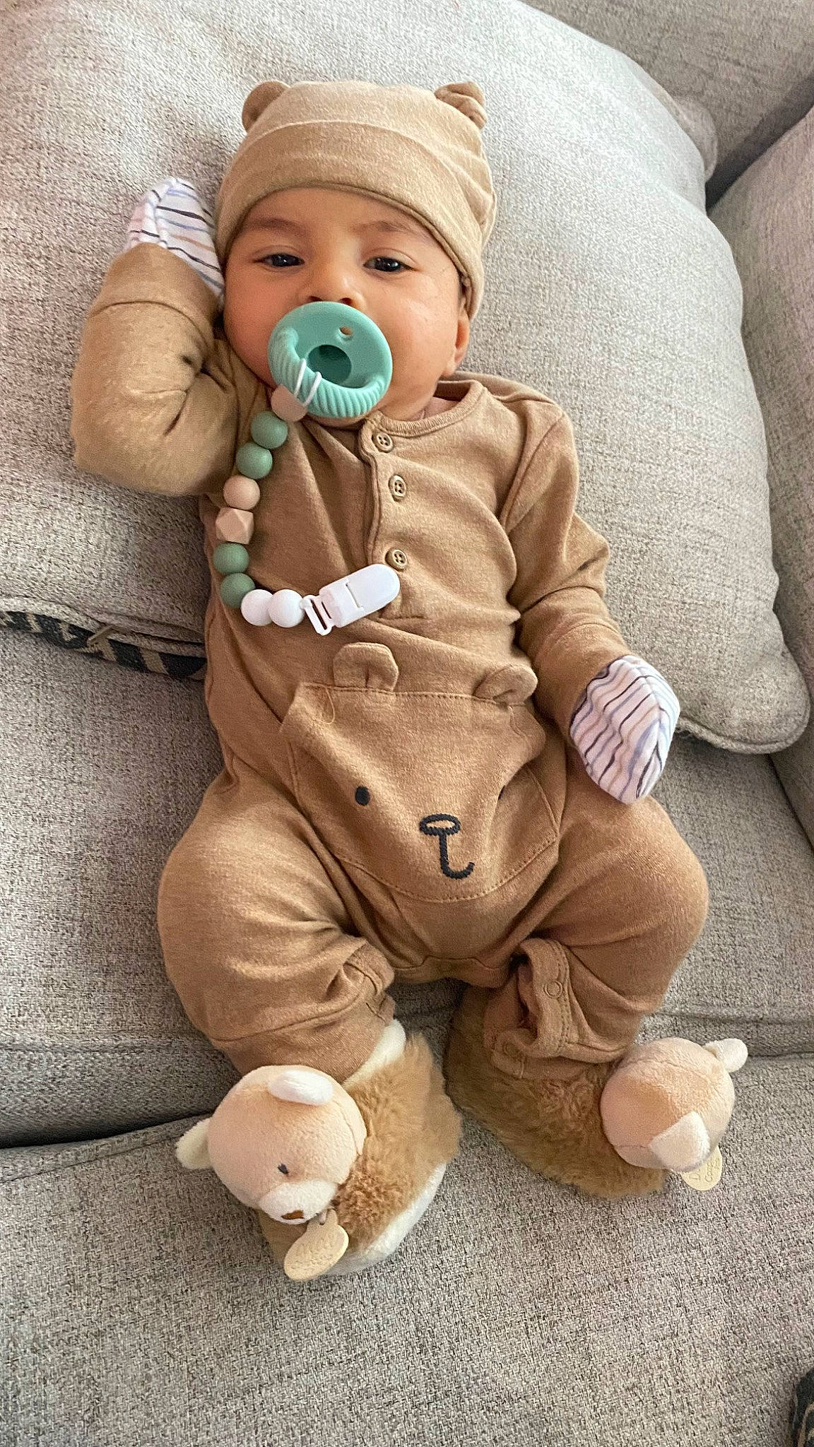 Luis is registered to the contest to win money with this photo: baby, baby_products, baby_toddler_clothing, cheek, child, comfort, flooring, foot, fur, happy, headwear, pattern, person, personal_protective_equipment, sitting, skin, sleeve, stuffed_toy, textile, thumb