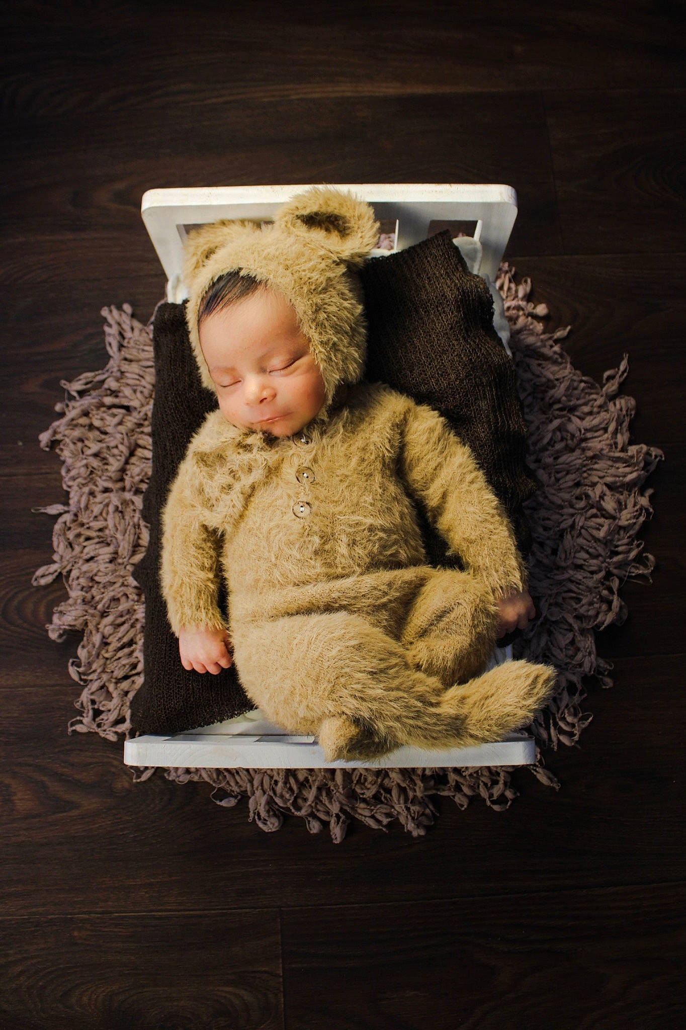 Luis is registered to the contest to win money with this photo: baby, baby_toddler_clothing, beanie, cap, chair, child, comfort, event, fashion_accessory, fur, fur_clothing, knit_cap, linens, person, portrait_photography, sitting, sleeve, toddler, wood, wool