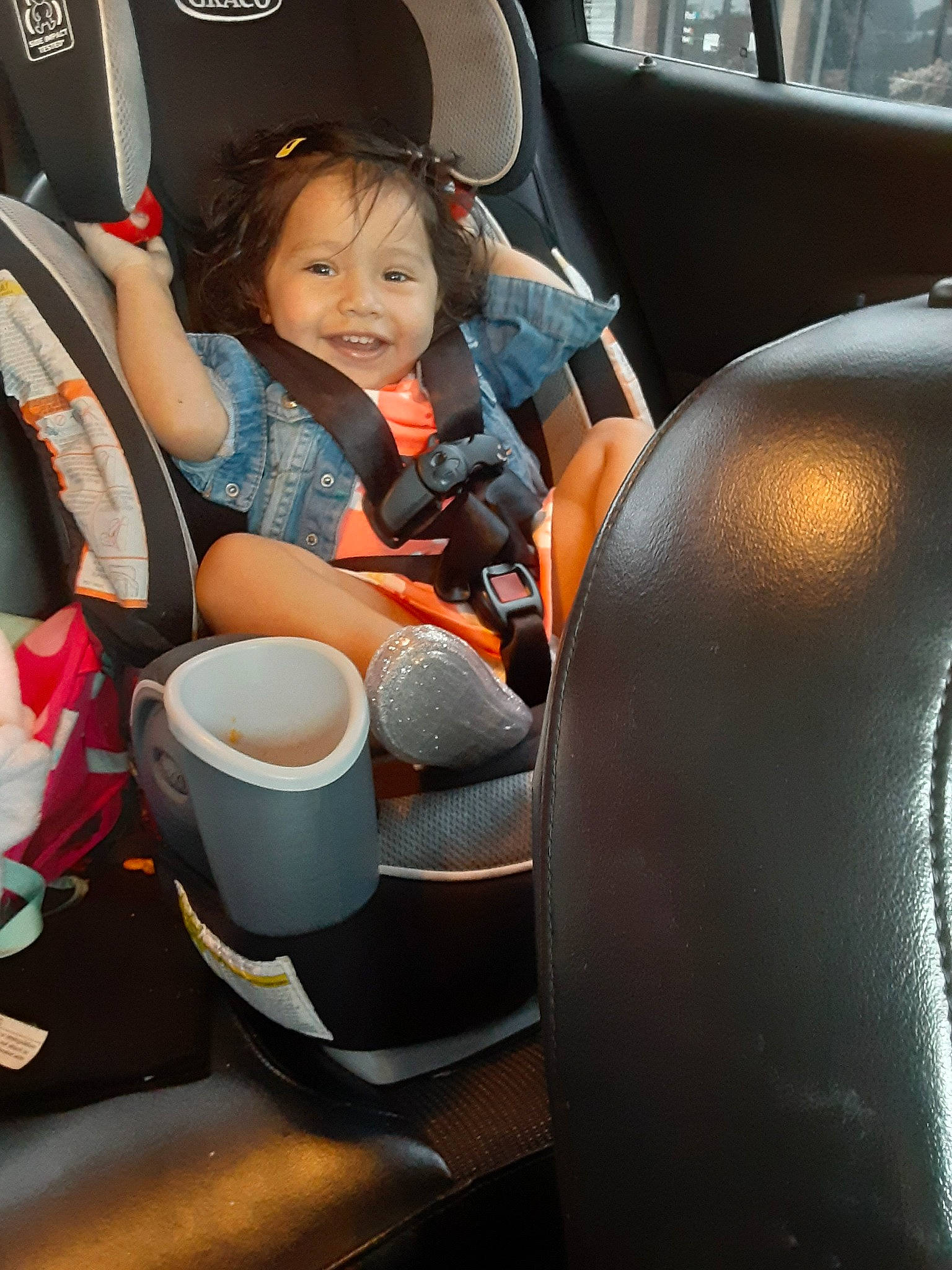 Jemma is registered to the contest to win money with this photo: auto_part, baby_in_car_seat, car, car_seat, car_seat_cover, child, driving, family_car, joy, person, plant, sitting, steering_part, steering_wheel, toddler, vehicle