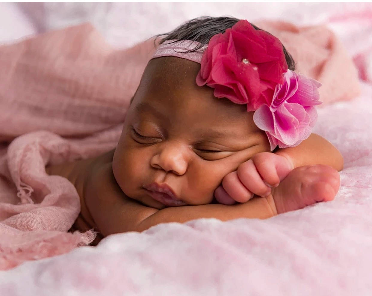 Skylar is registered to the contest to win money with this photo: baby, baby_sleeping, baby_toddler_clothing, bedtime, cheek, child, comfort, face, fashion_accessory, gesture, happy, headgear, headwear, linens, nail, person, petal, pink, skin, smile