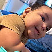 Emiliano joined the competition — help win amazing prizes! child, toddler, smiling, face, portrait, indoors, bed, bedding, shirt, brown_shirt, lying_down, leaning, close_up, happy, playful, candid, bedroom, home, arm, photography