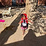 Kehlani joined the competition — help win amazing prizes! child, girl, costume, red_hood, barefoot, smiling, outdoor, tree, shadow, sunlight, dirt, house, brick_wall, window, door, chair, playful, happy, daytime, nature