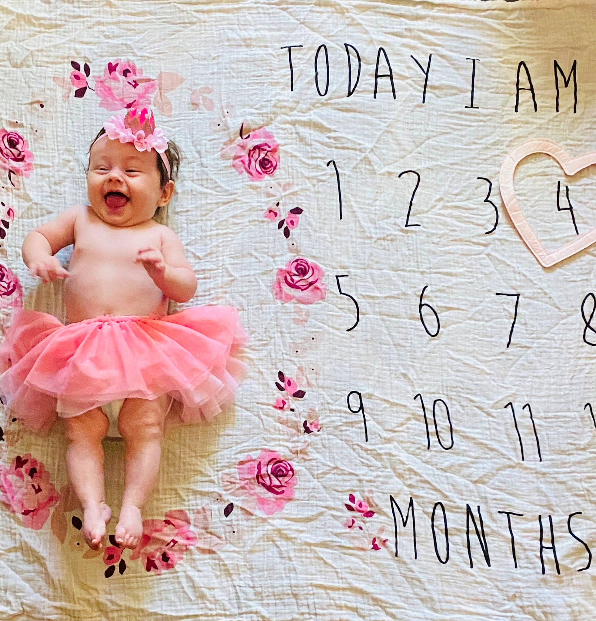 Kensley joined the competition — help win amazing prizes! baby, baby_toddler_clothing, ballet_tutu, day_dress, fashion_accessory, flooring, font, hair_accessory, handwriting, happy, headpiece, headwear, magenta, mythical_creature, pattern, person, petal, pink, ruffle, smile