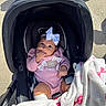 Alaia joined the competition — help win amazing prizes! baby, infant, child, car_seat, stroller, pink_outfit, hair_bow, blanket, smiling, hand_to_mouth, portrait, outdoor, sunlight, pavement, crowd, sitting,  안전, cozy, travel, family
