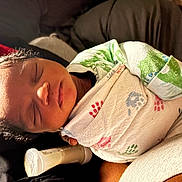 Nyaire is registered to the contest to win money with this photo: newborn, baby, sleeping, blanket, bottle, infant, swaddled, cozy, peaceful, child, cute, resting, indoors, soft_light, portrait, human, toddler, young_child, family, love