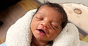 Nyaire joined the competition — help win amazing prizes! baby, sleeping, blanket, drool, indoor, infant, child, cozy, cute, wrapped, face, peaceful, smile, wall_decor, rocket, furniture, floor, person, newborn, toddler