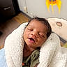 baby, sleeping, blanket, drool, indoor, infant, child, cozy, cute, wrapped, face, peaceful, smile, wall_decor, rocket, furniture, floor, person, newborn, toddler
