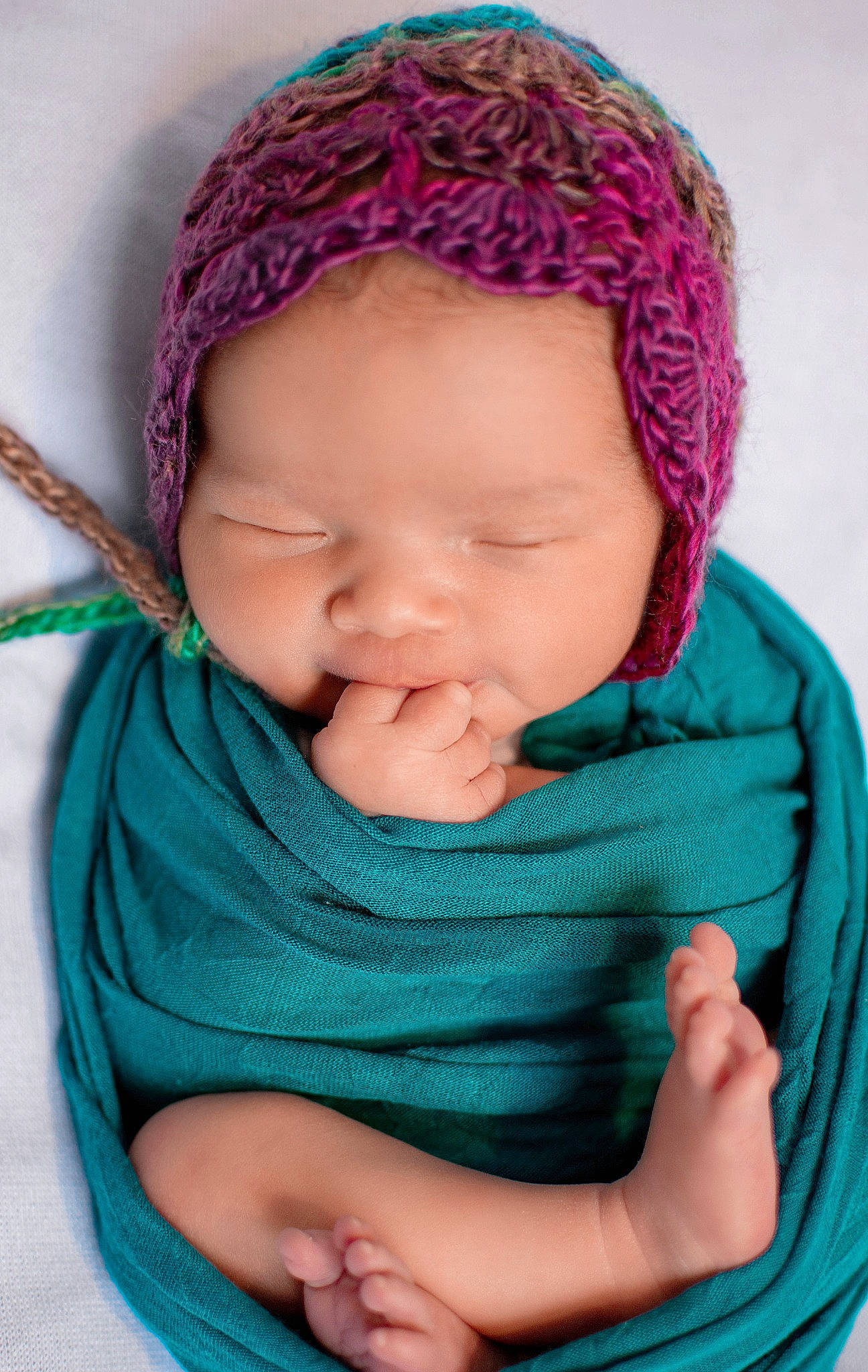 Evie is registered to the contest to win money with this photo: baby, cheek, child, crochet, face, forehead, hand, head, headgear, headwear, knitting, lip, person, pink, purple, skin, textile, toddler, turquoise, wool