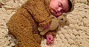 Riley joined the competition — help win amazing prizes! baby, sleeping, bear_costume, crocheted_blanket, teddy_bear, infant, cute, cozy, soft_texture, handmade, knitwear, child, peaceful, resting, portrait, warm_colors, fuzzy_clothing, adorable, laying_down, nursery