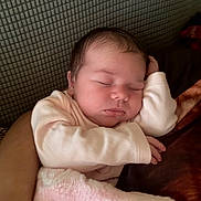 Carmen is registered to the contest to win money with this photo: arm, baby, blanket, child, closeup, clothing, cozy, cute, face, indoors, infant, newborn, peaceful, person, pink, portrait, relaxing, resting, sleeping, soft