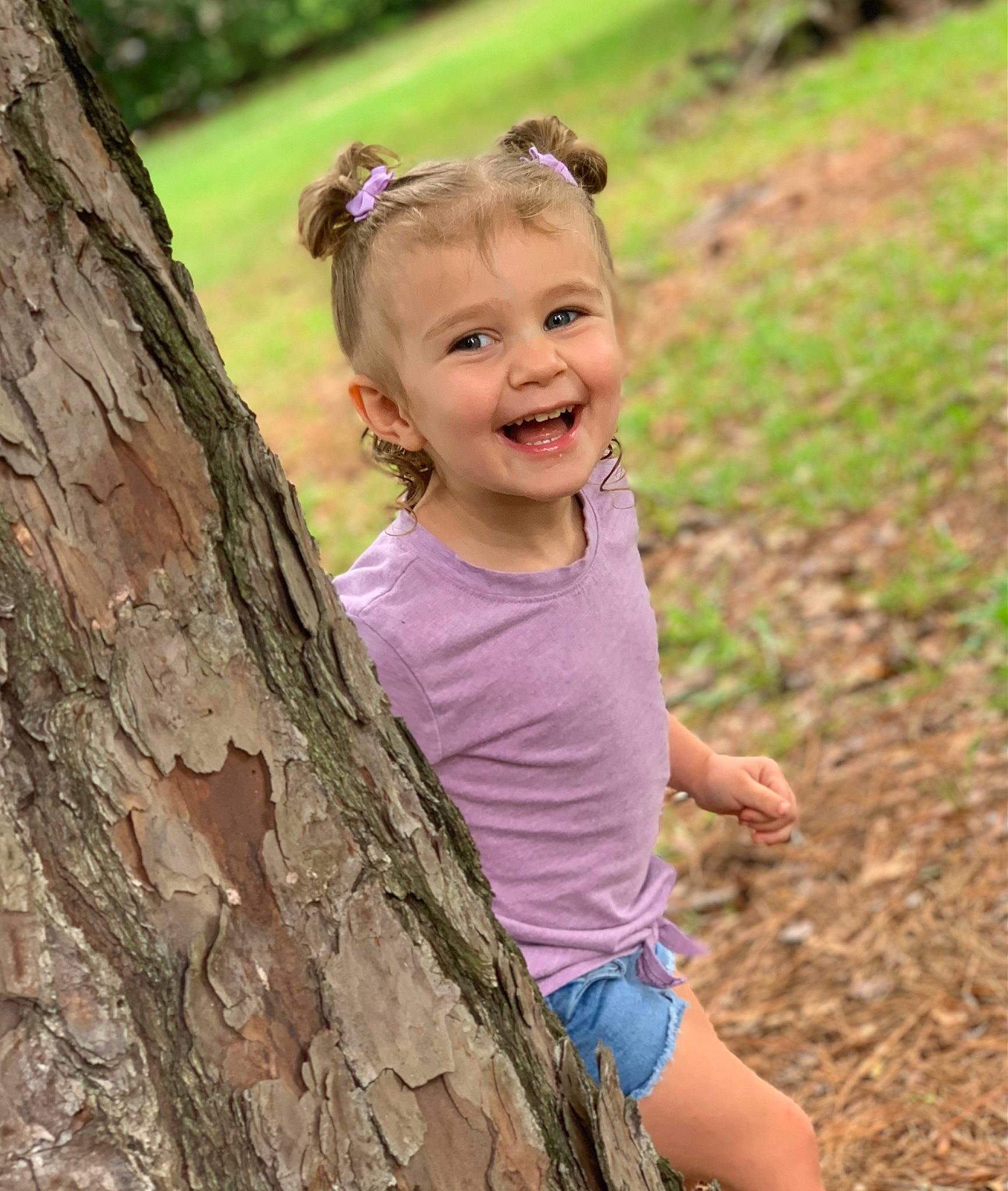 Aubree is registered to the contest to win money with this photo: blond, child, forest, fun, grass, grassland, happy, joy, leaf, leisure, people_in_nature, person, plant, recreation, shorts, smile, soil, toddler, tree, trunk