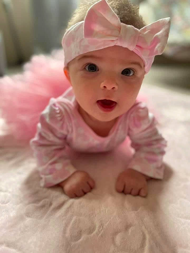 Harper joined the competition — help win amazing prizes! baby, baby_toddler_clothing, cap, cheek, child, eye, fashion_accessory, flooring, grass, happy, head, headpiece, headwear, human_body, linens, magenta, person, petal, pink, sleeve