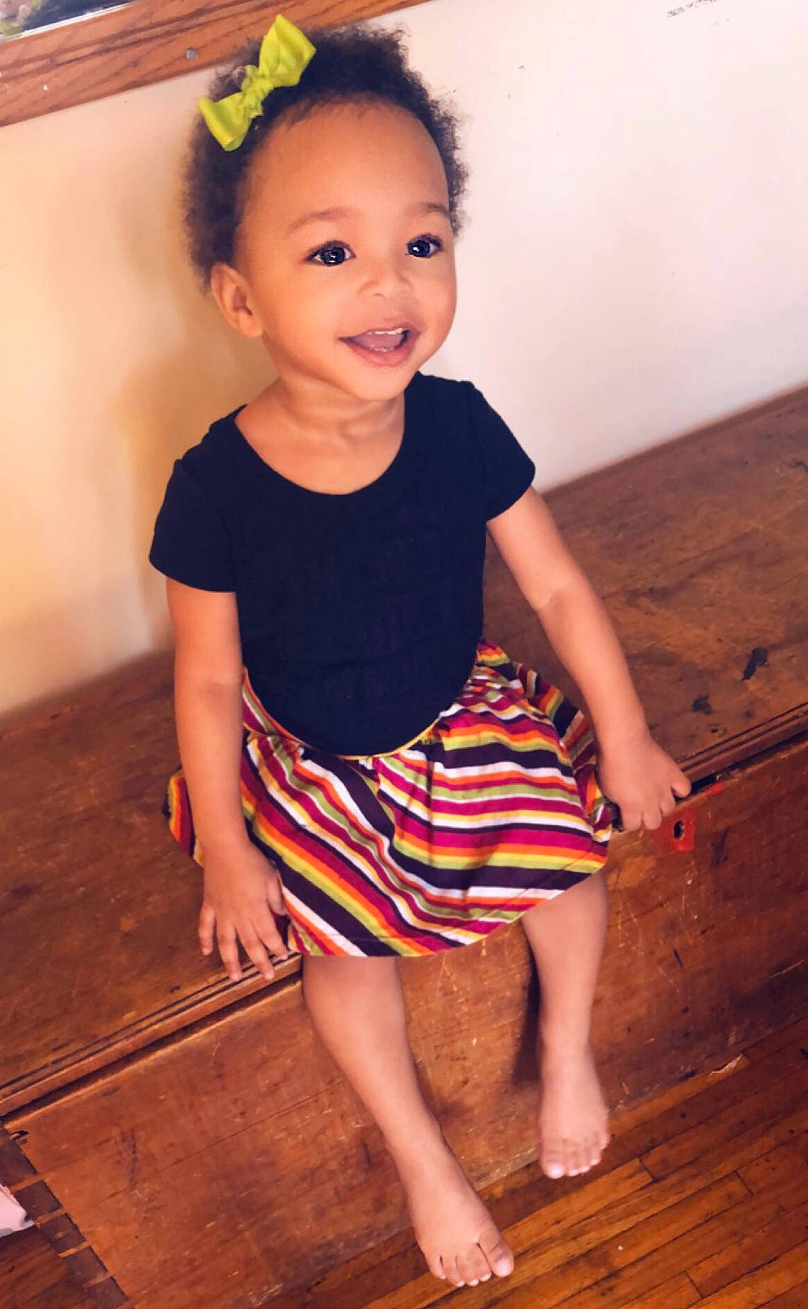 Melia is registered to the contest to win money with this photo: baby_toddler_clothing, barefoot, child, child_model, clothing, costume, floor, joy, leg, person, shoe, sitting, skin, smile, standing, toddler