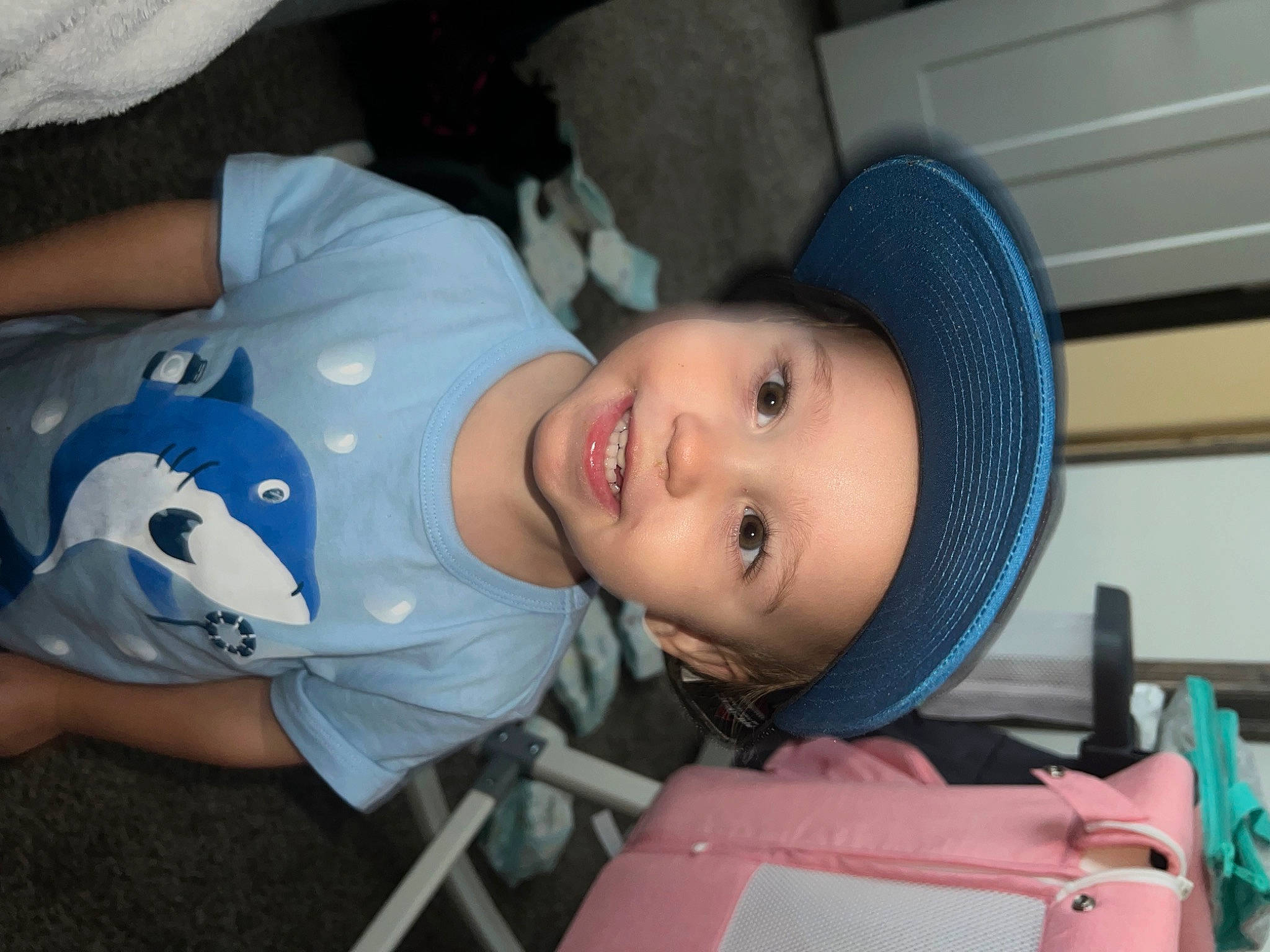 Liam is registered to the contest to win money with this photo: baby, baby_products, baby_toddler_clothing, chair, cheek, child, comfort, electric_blue, eye, fashion_accessory, fun, happy, headwear, joy, mouth, nose, person, sitting, skin, smile