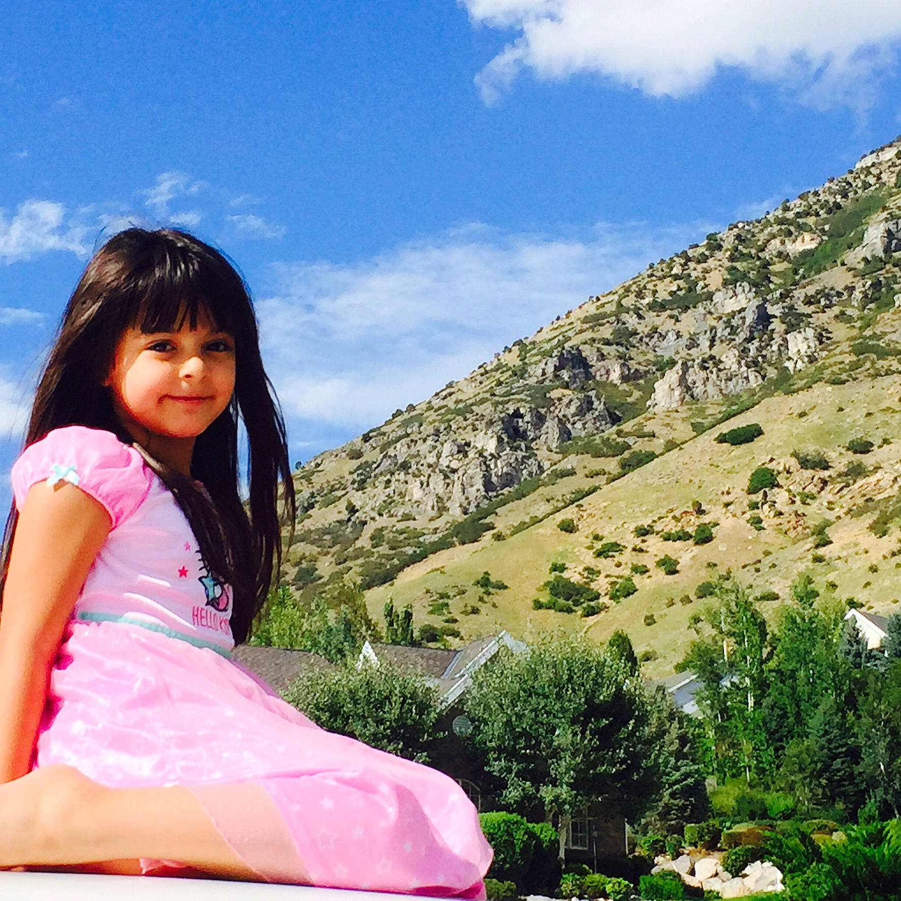 Ezrihana is registered to the contest to win money with this photo: beauty, child, cloud, grass, green, happy, lady, leisure, mountain, people_in_nature, person, pink, sitting, skin, sky, smile, spring, summer, tourism, tree