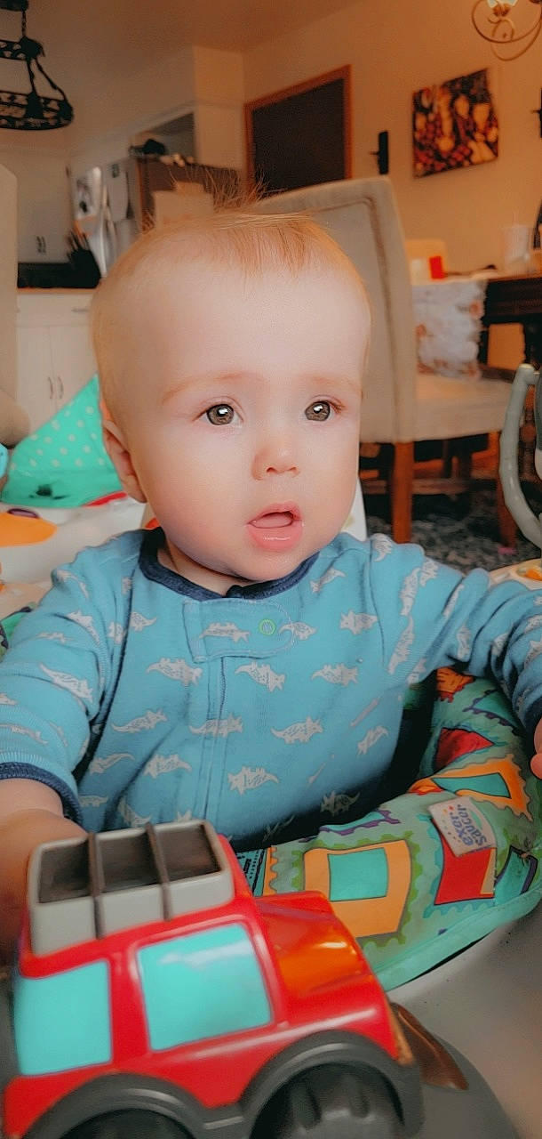 Noah joined the competition — help win amazing prizes! baby, baby_products, baby_toddler_clothing, chair, cheek, child, eye, eyelash, fun, happy, head, mouth, nose, person, product, room, sitting, skin, smile, toddler