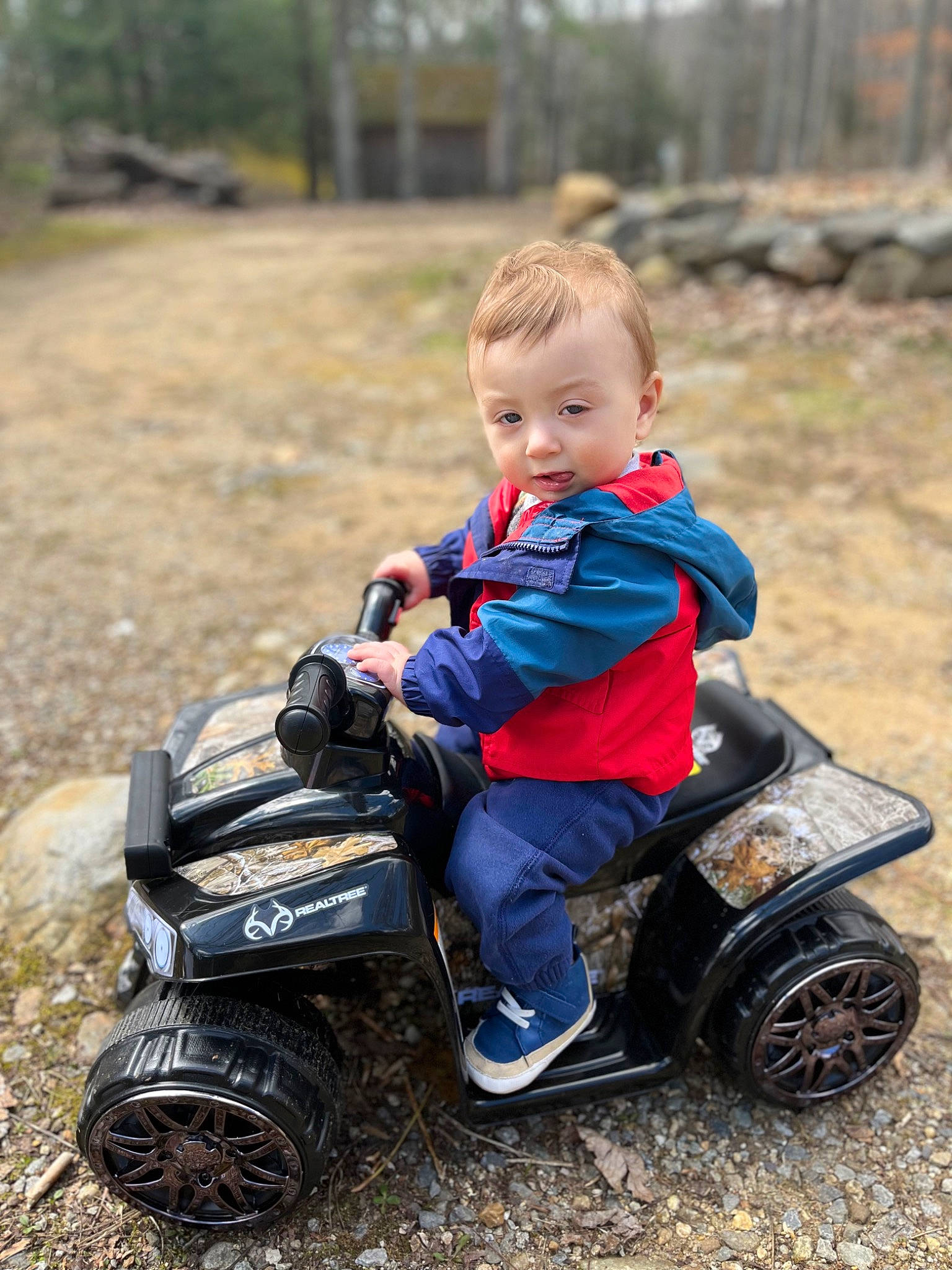 Frankie is registered to the contest to win money with this photo: automotive_tire, automotive_wheel_system, baby, baby_toddler_clothing, child, fun, grass, happy, motor_vehicle, people_in_nature, person, recreation, riding_toy, rolling, shoe, sneakers, tire, toddler, tree, vehicle