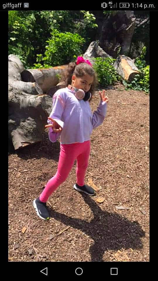 Alexia is registered to the contest to win money with this photo: boot, botany, fun, grass, happy, landscape, leaf, leisure, magenta, mammal, people_in_nature, person, pink, plant, recreation, soil, sweatpant, t_shirt, tree, vertebrate