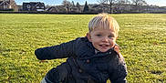 Alfie joined the competition — help win amazing prizes! blond_hair, blue_sky, casual_clothing, child, cute, daylight, field, grass, happy, jacket, nature, outdoor, park, playful, portrait, rain_boots, smile, sunny, toddler, young