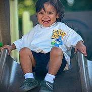 João joined the competition — help win amazing prizes! child, toddler, smiling, slide, playground, outdoor, white_tshirt, cartoon_print, shorts, shoes, socks, happy, playing, fun, leisure, summer, daylight, portrait, cute, active