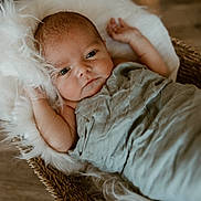 Mason joined the competition — help win amazing prizes! baby, infant, wrapped, blanket, basket, wicker, fur, soft, cozy, lying_down, face, eyes, skin, newborn, cute, peaceful, indoor, portrait, child, resting