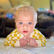 Emmett joined the competition — help win amazing prizes! baby, blue_eyes, yellow_clothing, checkered_pattern, blanket, infant, face, hands, lying_down, portrait, cute, indoor, soft_focus, expression, child, young, skin, head, mouth_open, person