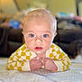 baby, blue_eyes, yellow_clothing, checkered_pattern, blanket, infant, face, hands, lying_down, portrait, cute, indoor, soft_focus, expression, child, young, skin, head, mouth_open, person