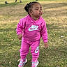 toddler, child, pink, nike, tracksuit, outdoor, grass, closed_eyes, shoes, sneakers, person, young_child, park, daylight, casual_clothing, standing, nature, cute, fashion, calm